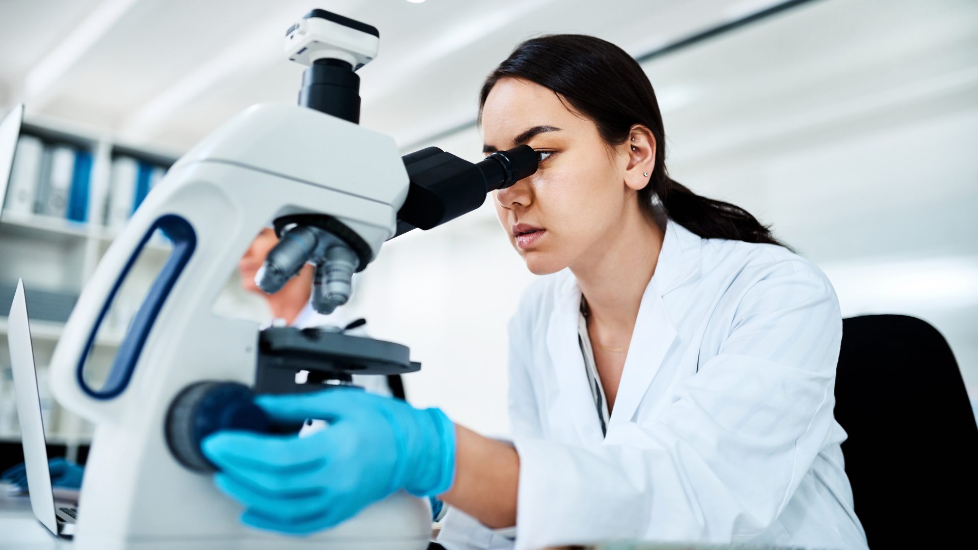Person at a microscope. 